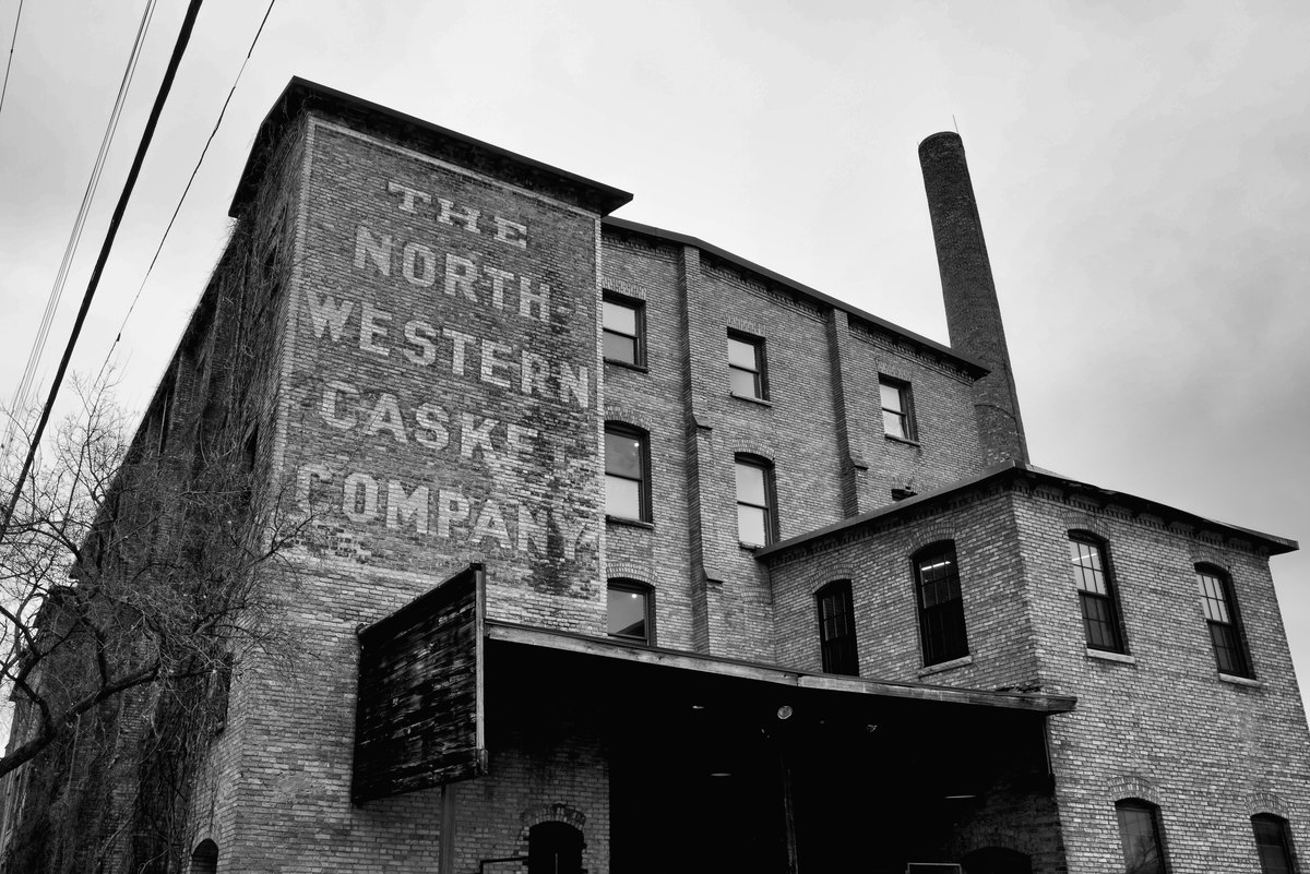 The Northwestern Casket Company ghost sign and chimney at the Casket Arts building